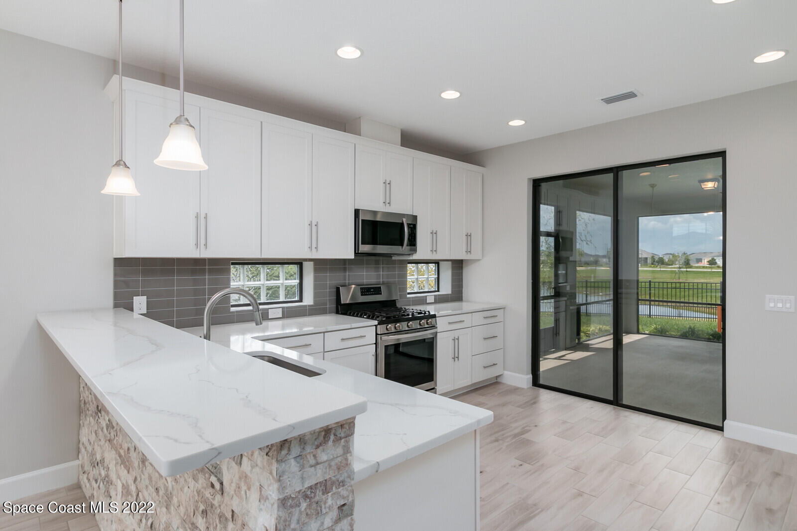3289 Ribbon Grass Drive Melbourne, FL 32940 - Photo 7 of 58 a kitchen with a sink a counter top space cabinets and stainless steel appliances