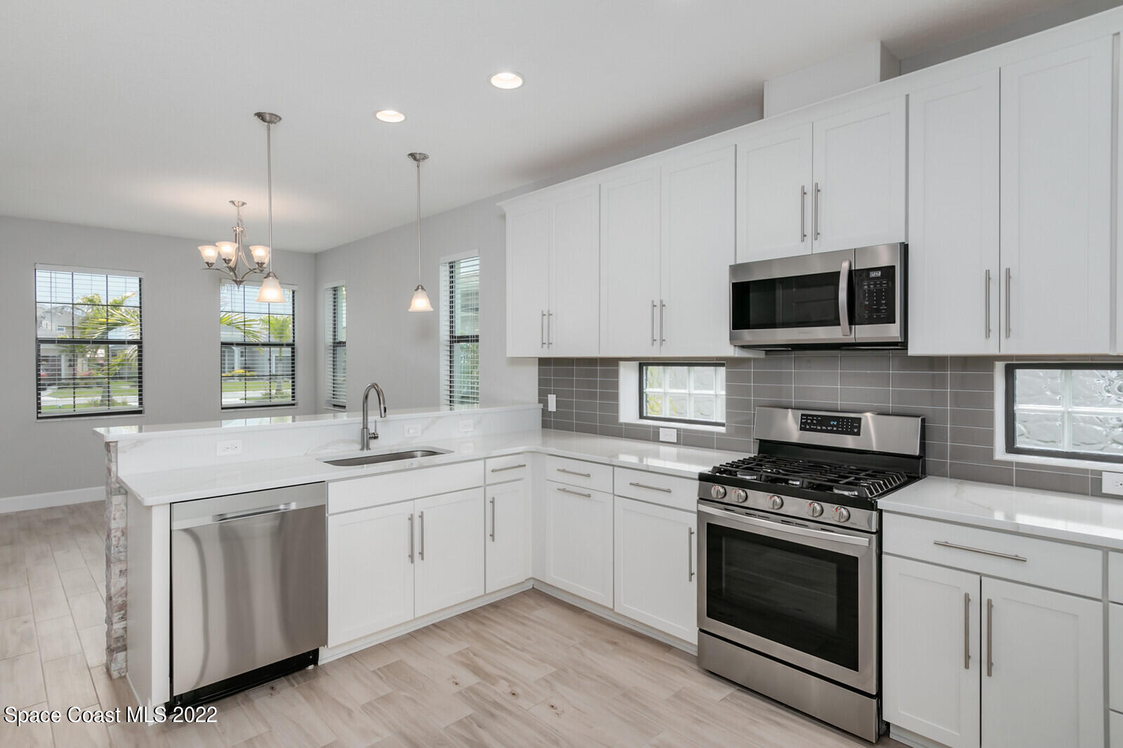 3289 Ribbon Grass Drive Melbourne, FL 32940 - Photo 8 of 58 a kitchen with granite countertop white cabinets and stainless steel appliances