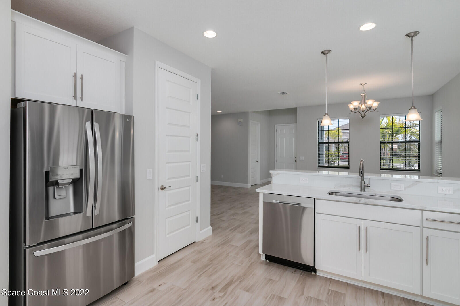 3289 Ribbon Grass Drive Melbourne, FL 32940 - Photo 9 of 58 a kitchen with a refrigerator sink and cabinets
