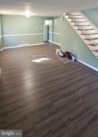 a view of a room with wooden floor