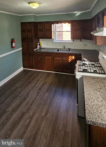 a kitchen with stainless steel appliances granite countertop a stove and a refrigerator