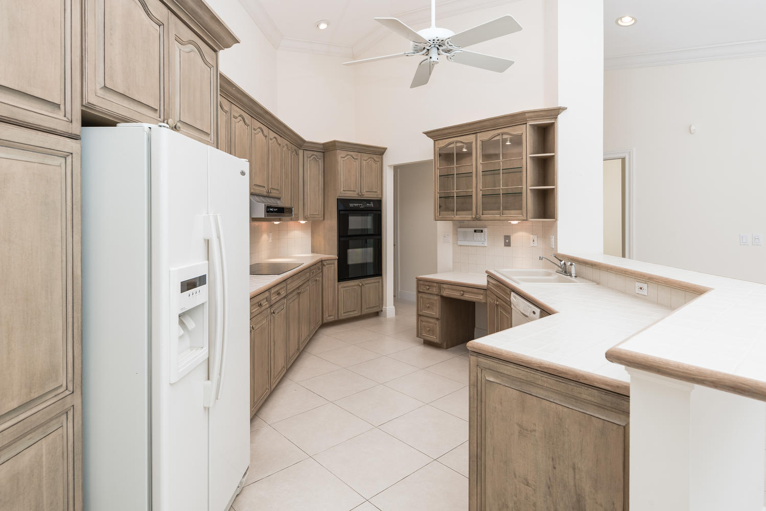 2245 Parkside Street Boca Raton, FL 33486 - Photo 12 of 34 a kitchen with stainless steel appliances a refrigerator sink and stove