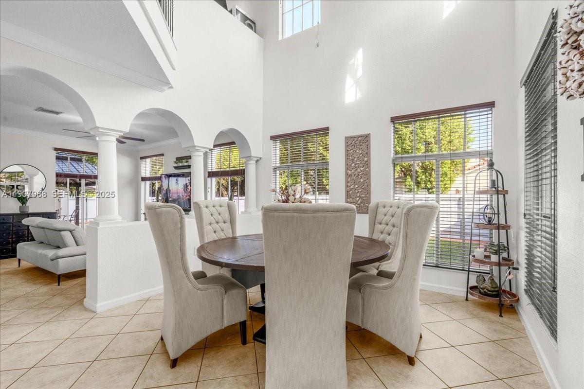 14027 Southwest 274th Terrace Homestead, FL 33032 - Photo 16 of 65 a view of a dining room with furniture window and outside view