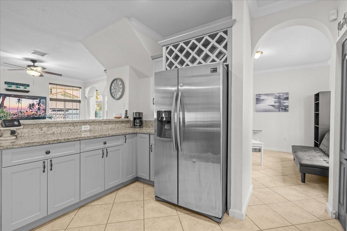 14027 Southwest 274th Terrace Homestead, FL 33032 - Photo 26 of 65 a kitchen with granite countertop a refrigerator and a sink