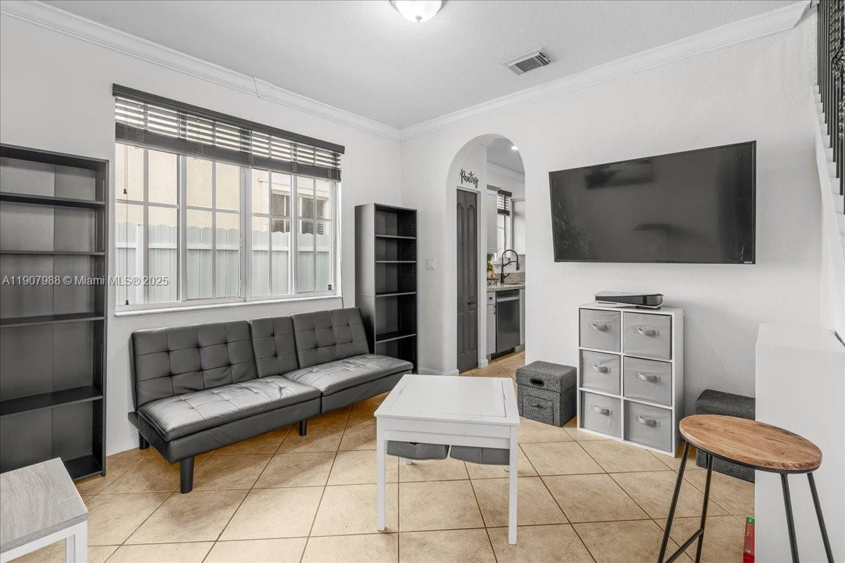 14027 Southwest 274th Terrace Homestead, FL 33032 - Photo 29 of 65 a living room with furniture and a flat screen tv