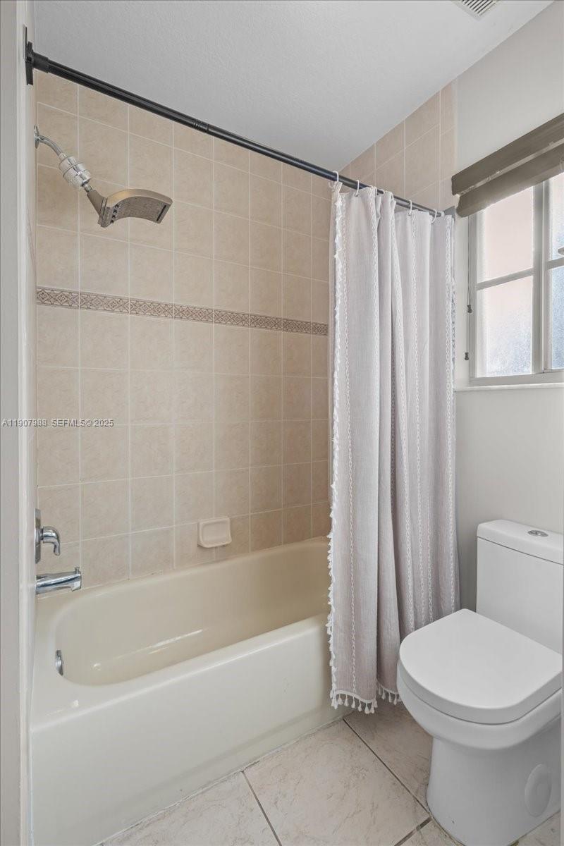 14027 Southwest 274th Terrace Homestead, FL 33032 - Photo 38 of 65 a bathroom with a toilet and a bathtub