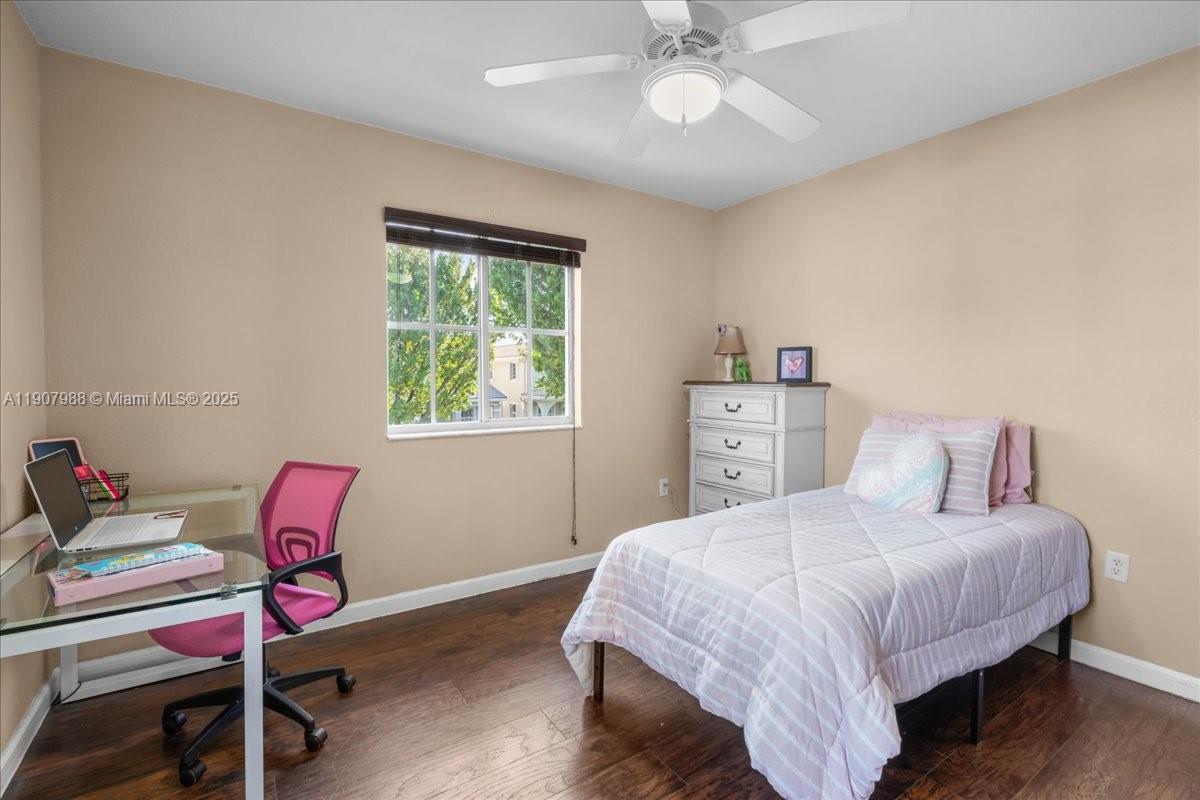 14027 Southwest 274th Terrace Homestead, FL 33032 - Photo 40 of 65 a bedroom with a bed and a chandelier