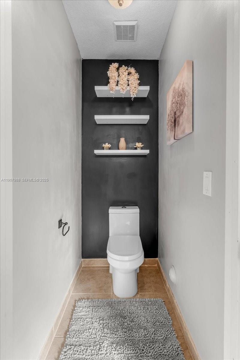 14027 Southwest 274th Terrace Homestead, FL 33032 - Photo 52 of 65 a bathroom with a toilet and a shower