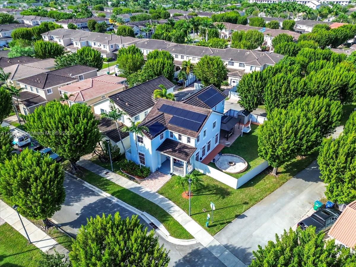 14027 Southwest 274th Terrace Homestead, FL 33032 - Photo 6 of 65 an aerial view of a house with garden space and street view