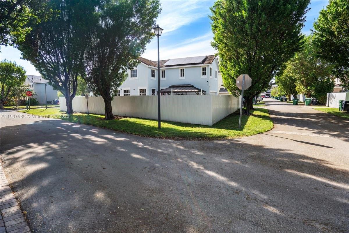 14027 Southwest 274th Terrace Homestead, FL 33032 - Photo 10 of 65 a view of a street with a house