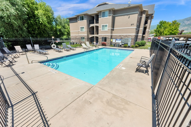 909 South Main Street, Unit G Layton, UT 84041 - Photo 21 of 25 Outdoor swimming pool with concrete decking and metal perimeter fencing