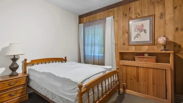 a bedroom with a bed and a dresser