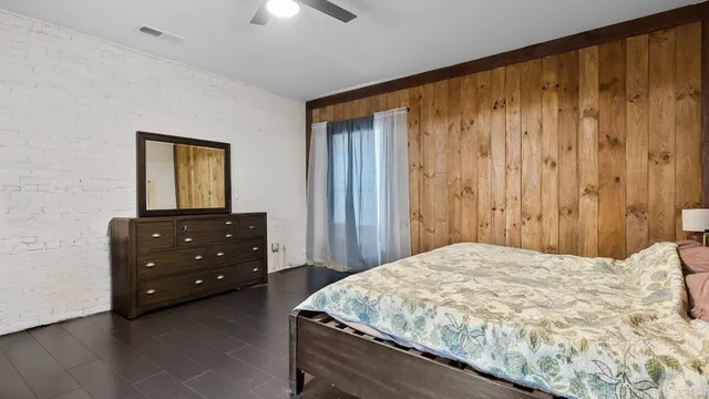 a bedroom with a bed and a dresser