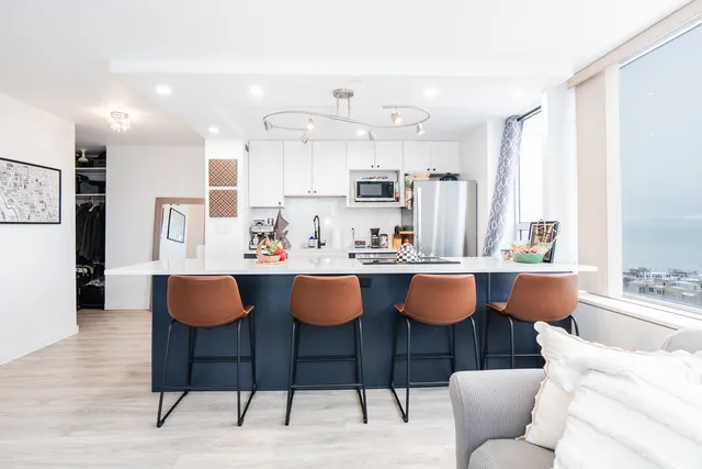 a view of kitchen with granite countertop dining room cabinets and stainless steel appliances