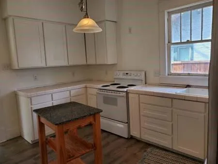 a kitchen with a sink cabinets and window