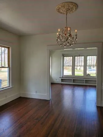 a view of a room with wooden floor and windows