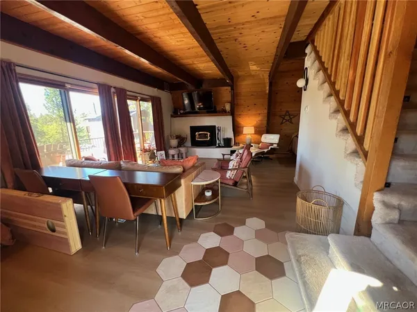 a living room with fireplace furniture and a large window