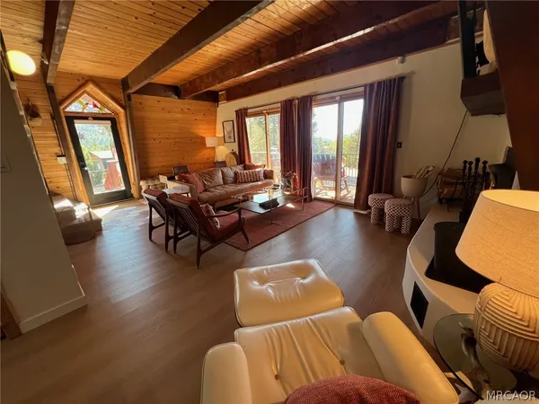 a living room with furniture and large windows