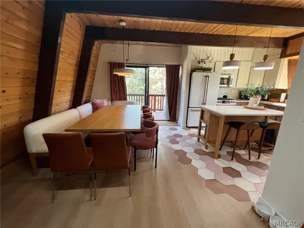 a dining room with a wooden table and chairs