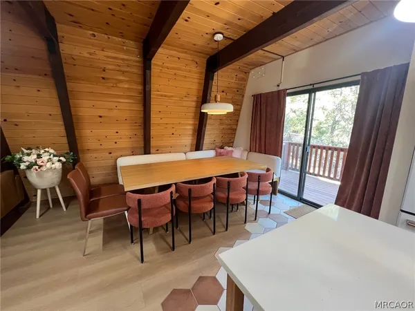 a view of a dining room with furniture and chandelier
