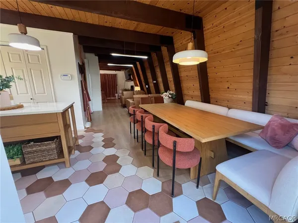 a view of a dining room with furniture and a rug