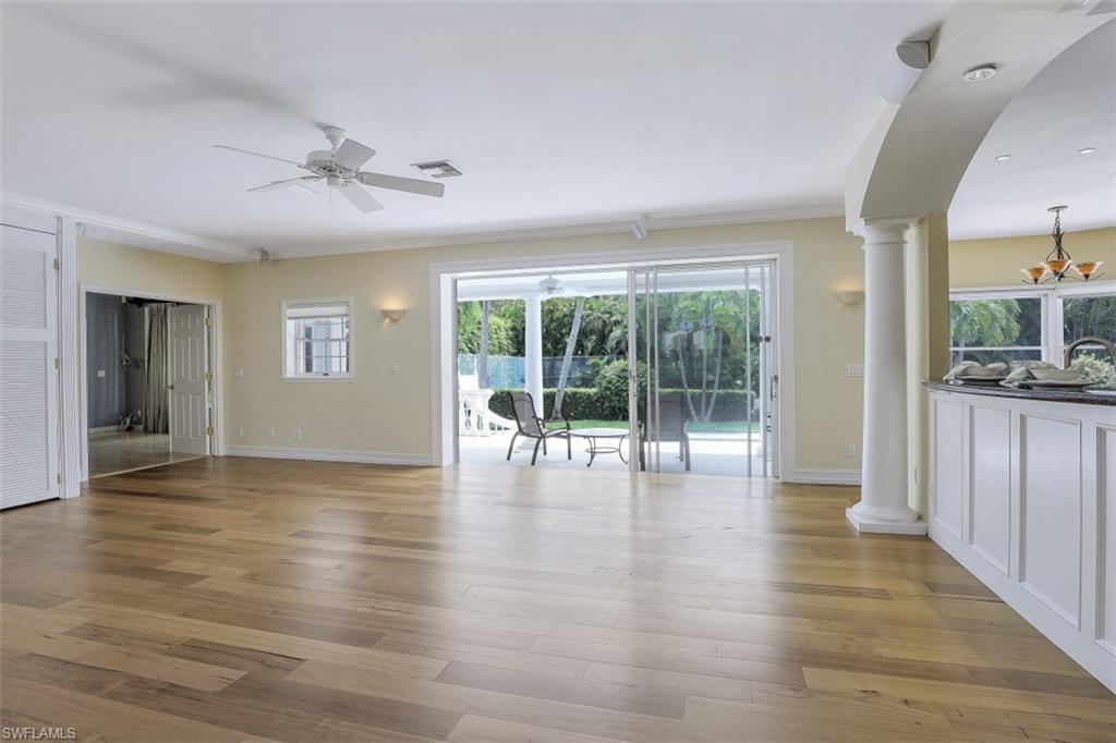 3277 Gordon Drive Naples, FL 34102 - Photo 11 of 33 a view of an empty room with wooden floor and a window