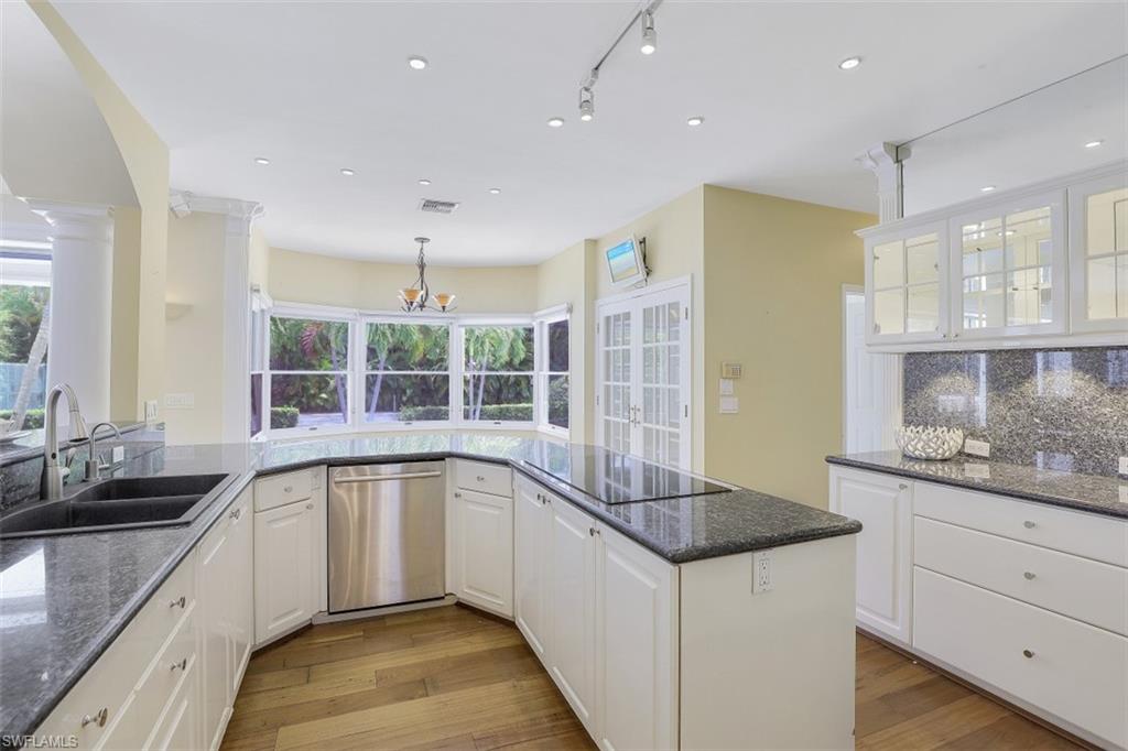 3277 Gordon Drive Naples, FL 34102 - Photo 13 of 33 a kitchen with granite countertop a sink and a stove