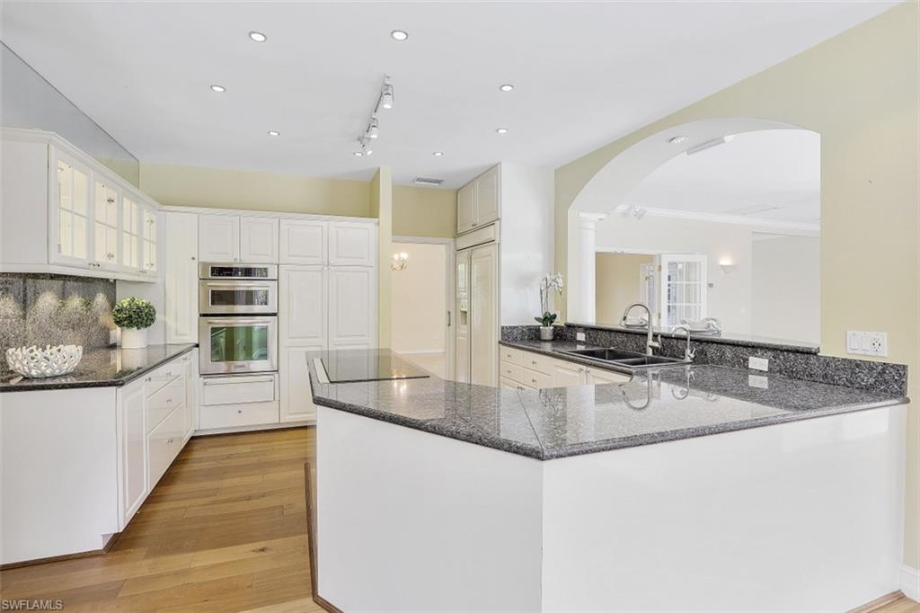 3277 Gordon Drive Naples, FL 34102 - Photo 17 of 33 a large kitchen with stainless steel appliances lots of counter space and a sink