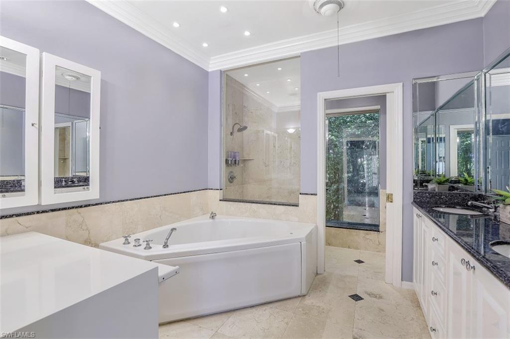 3277 Gordon Drive Naples, FL 34102 - Photo 19 of 33 a bathroom with a bathtub and a sink