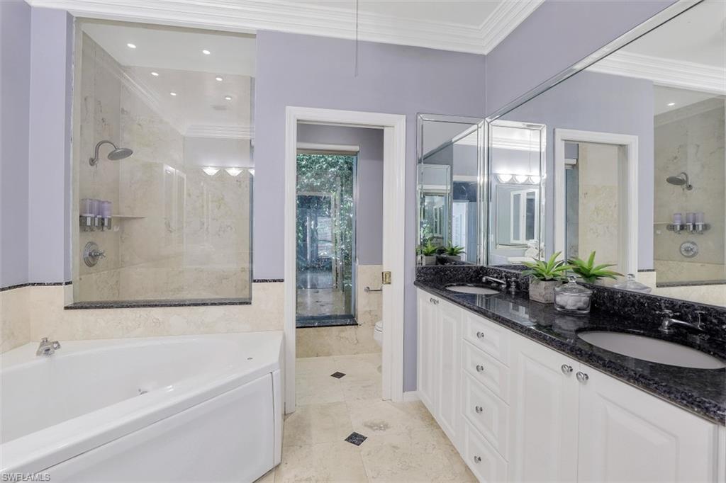 3277 Gordon Drive Naples, FL 34102 - Photo 20 of 33 a bathroom with a granite countertop tub sink and mirror