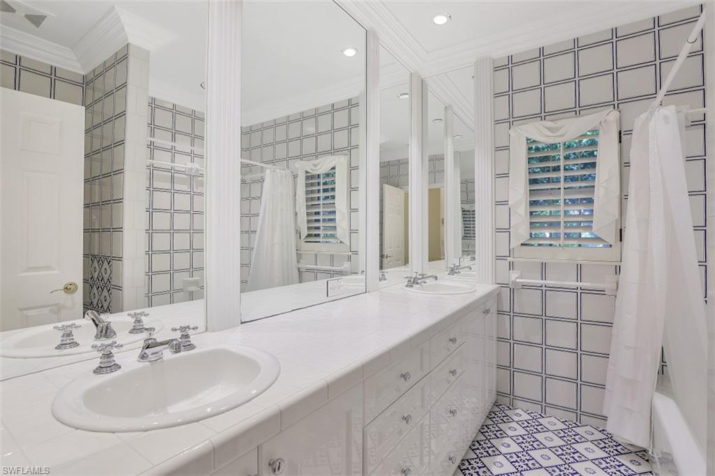 3277 Gordon Drive Naples, FL 34102 - Photo 22 of 33 a bathroom with a double vanity sink mirror and double