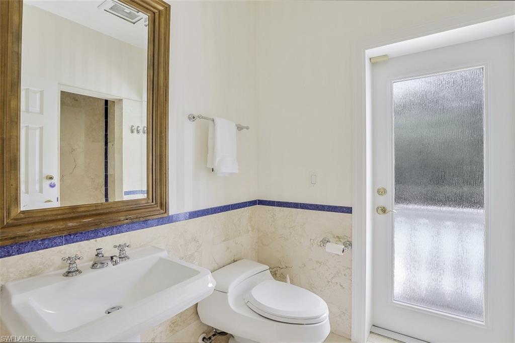 3277 Gordon Drive Naples, FL 34102 - Photo 24 of 33 a bathroom with a toilet a sink and shower