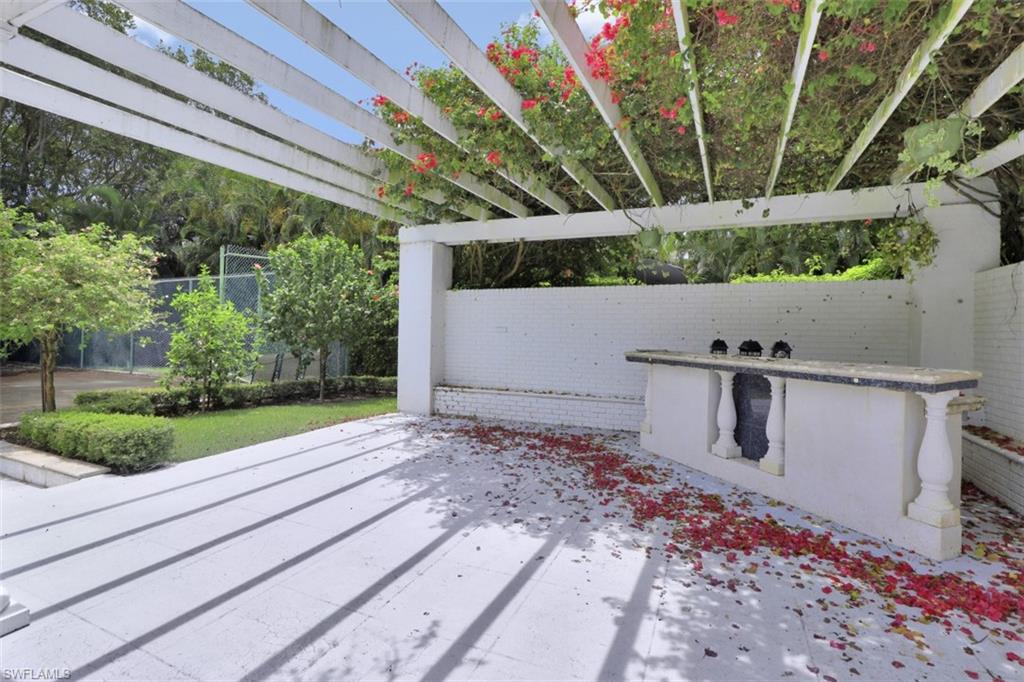 3277 Gordon Drive Naples, FL 34102 - Photo 26 of 33 a view of a yard with an outdoor space