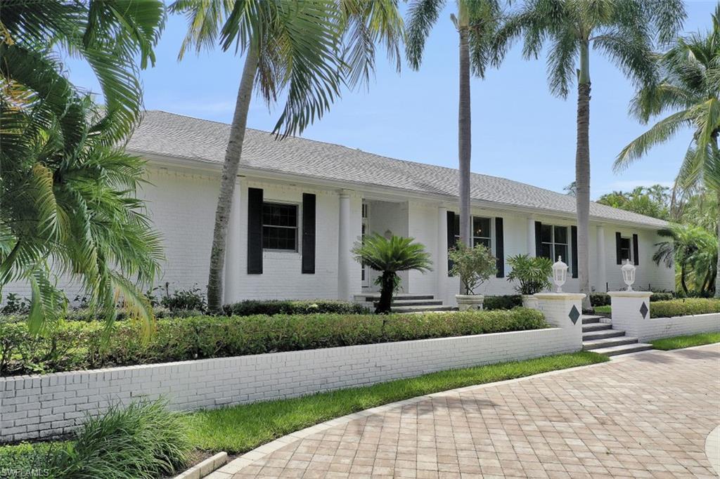 3277 Gordon Drive Naples, FL 34102 - Photo 4 of 33 a front view of house with yard and green space