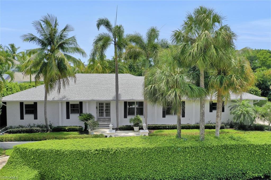 3277 Gordon Drive Naples, FL 34102 - Photo 5 of 33 a front view of house with yard and green space