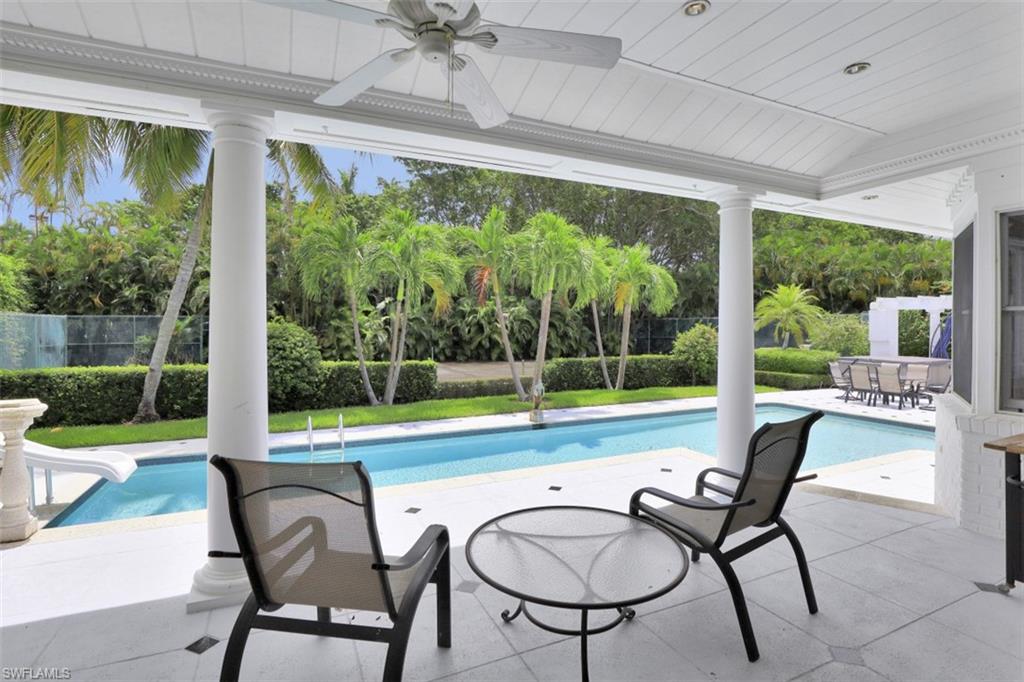 3277 Gordon Drive Naples, FL 34102 - Photo 9 of 33 a view of a swimming pool and outdoor seating