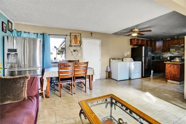 a living room with furniture a dining table and chairs