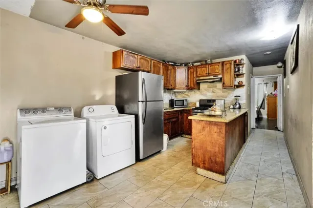 a kitchen with refrigerator and cabinets