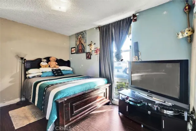 a bedroom with bed and a chandelier