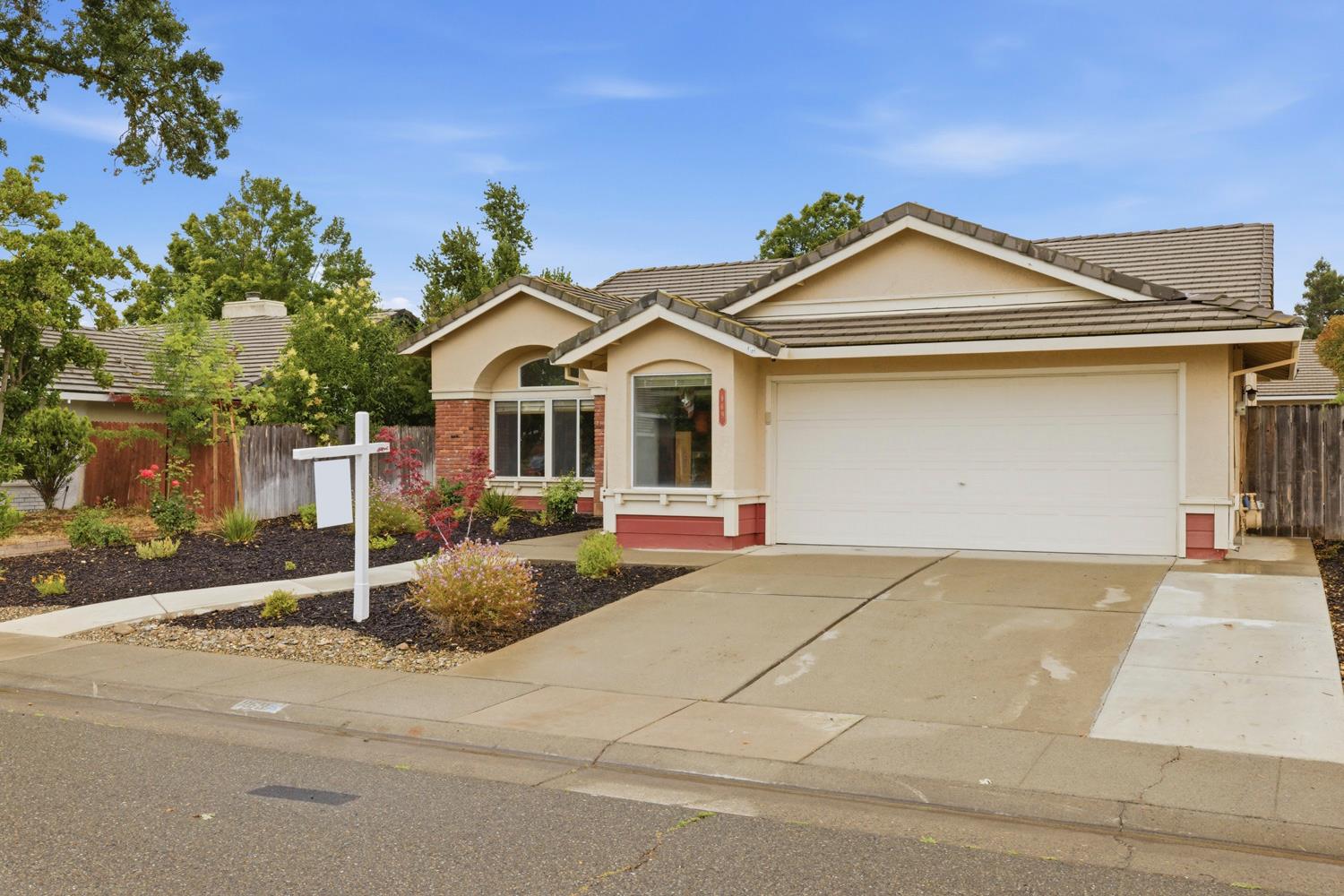 969 Colson Way Galt, CA 95632 - Photo 3 of 38 a front view of a house with a yard and garage