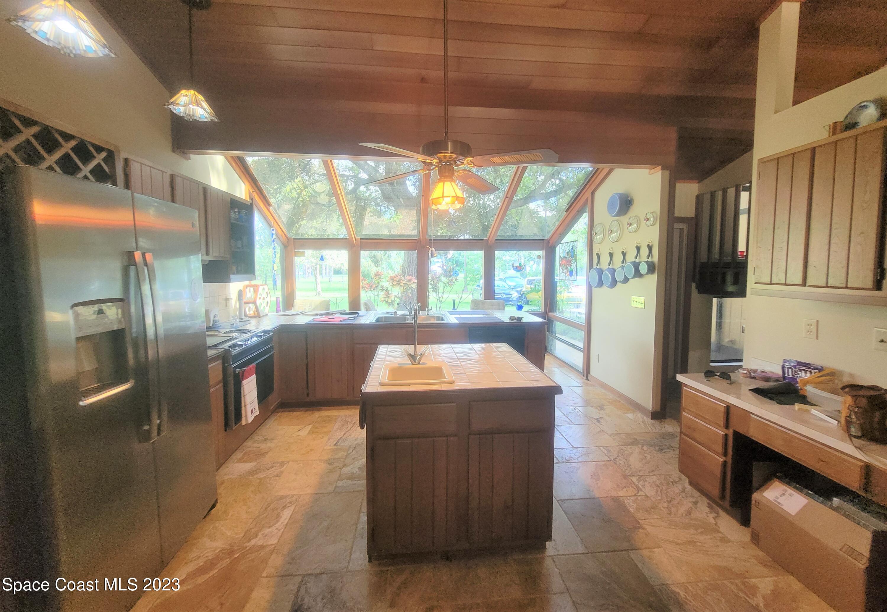 3805 Corey Road Malabar, FL 32950 - Photo 19 of 72 a kitchen with stainless steel appliances granite countertop a sink and a refrigerator