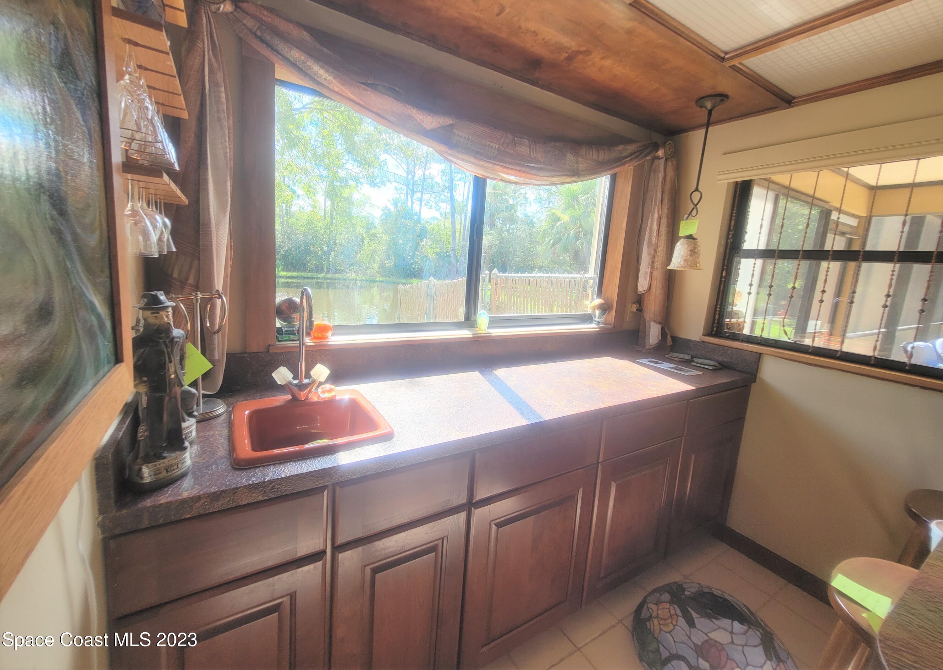 3805 Corey Road Malabar, FL 32950 - Photo 42 of 72 a living room with hard wood floors and a window