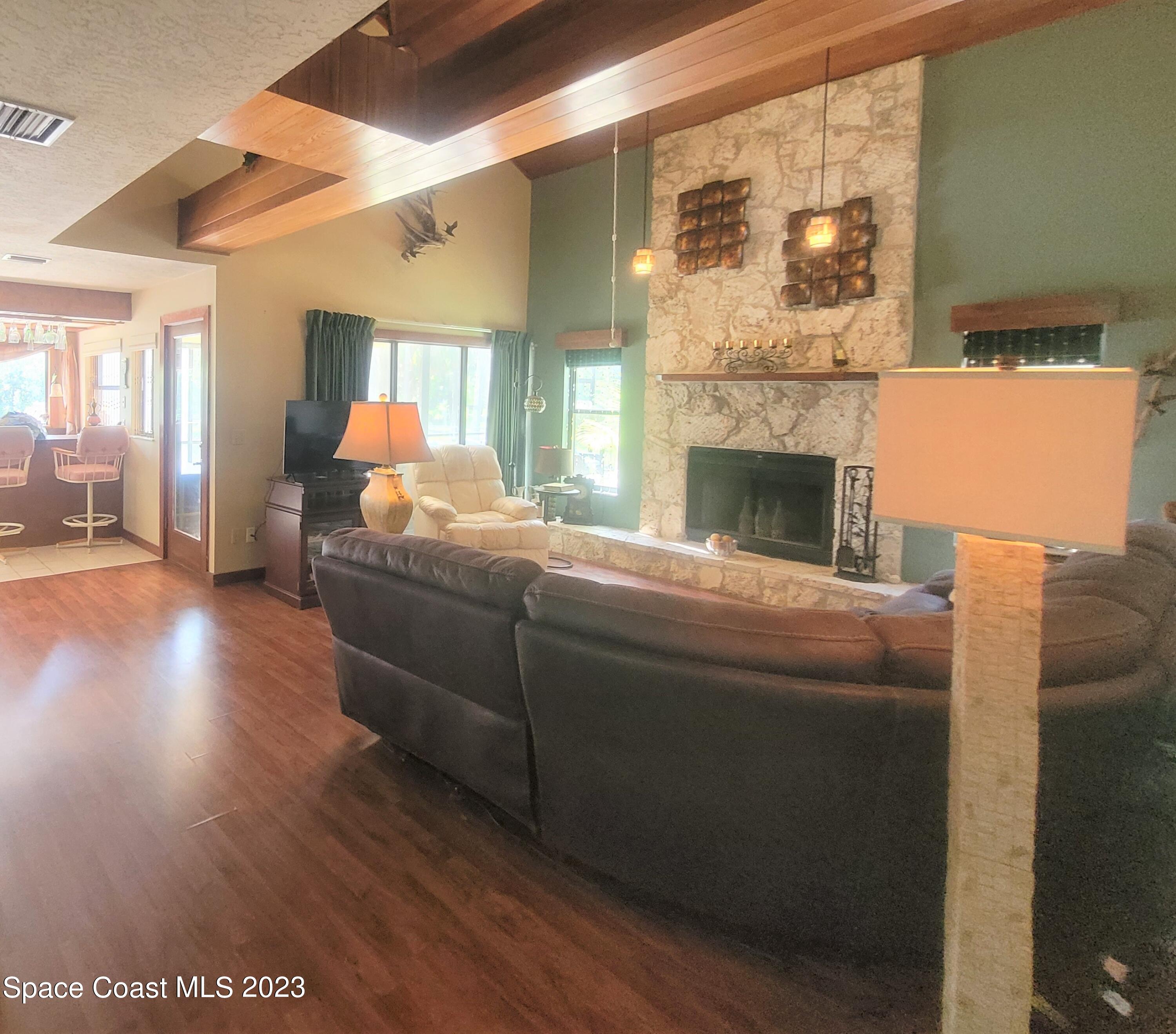3805 Corey Road Malabar, FL 32950 - Photo 7 of 72 a living room with furniture and a fireplace