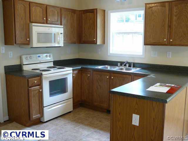 8408 Atlee Road Mechanicsville, VA 23116 - Photo 2 of 10 a kitchen with a sink stove and microwave