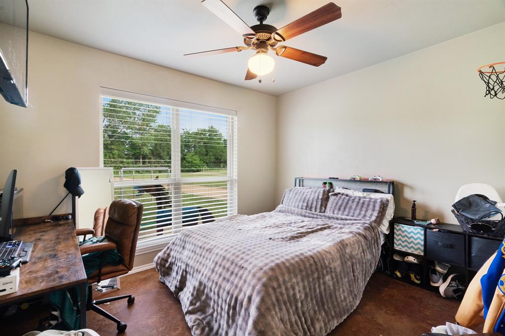 1890 County Road Sumner, TX 75486 - Photo 15 of 20 a bedroom with a bed and a desk