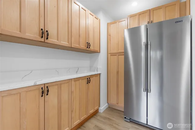 a kitchen with stainless steel appliances granite countertop a refrigerator and cabinets