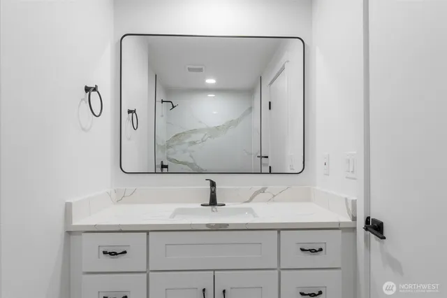 a bathroom with a sink and a mirror
