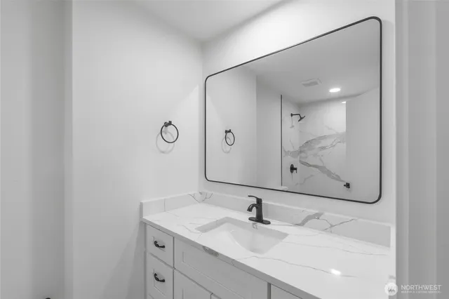 a bathroom with a sink and mirror