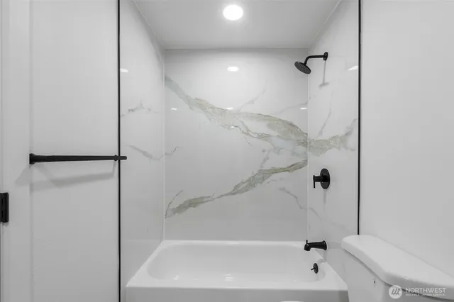 a bathroom with a bathtub and a shower