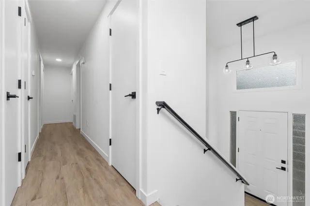 a view of a hallway with wooden floor and staircase